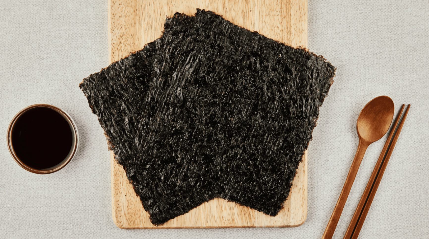 OHSUNG roasted seaweed sheets on a wooden board